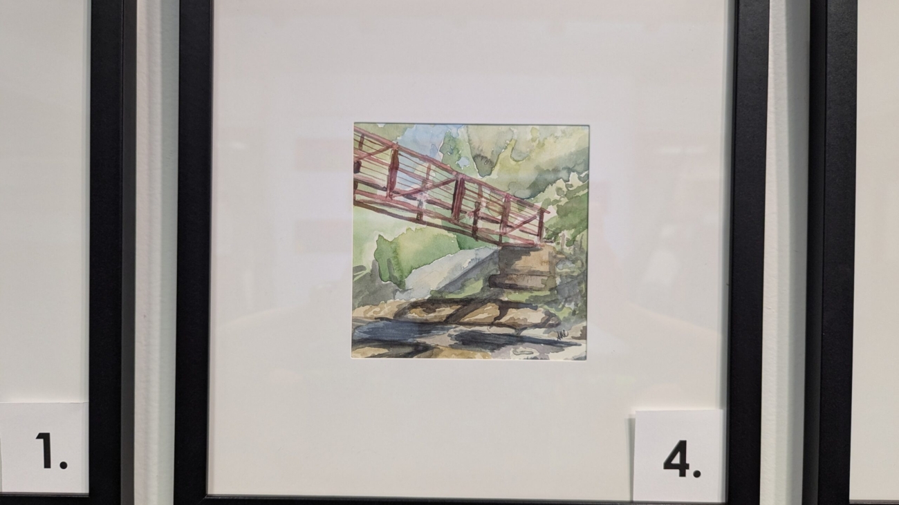 5x5 watercolor painting of a red bridge in Manchester, NH in a 10x10 frame.