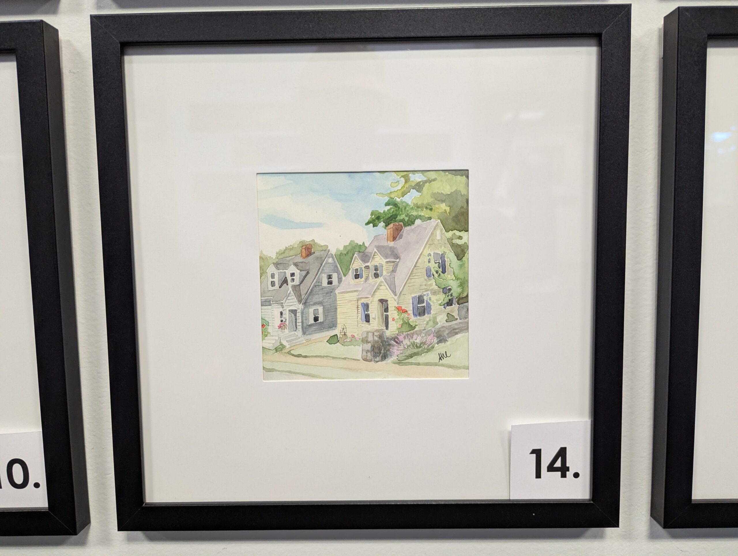 5x5 watercolor painting of two identically framed houses, one yellow, one grey in a 10x10 frame.
