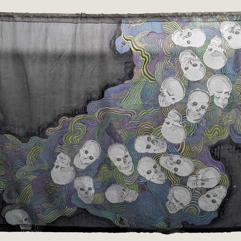 Silk painting strung between two bamboo poles. Skulls and abstract wavy lines.