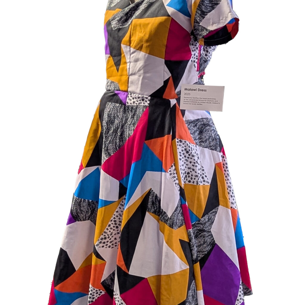 A loudly colored geometrically patterned wrap dress.