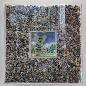 A dainty little 5 inch painting of a green house with a tree in front of it with a desperately blue sky is surrounded by a 6 inch thick and deep plexiglass frame filled with tiny pea gravel. The painting is lit from within.