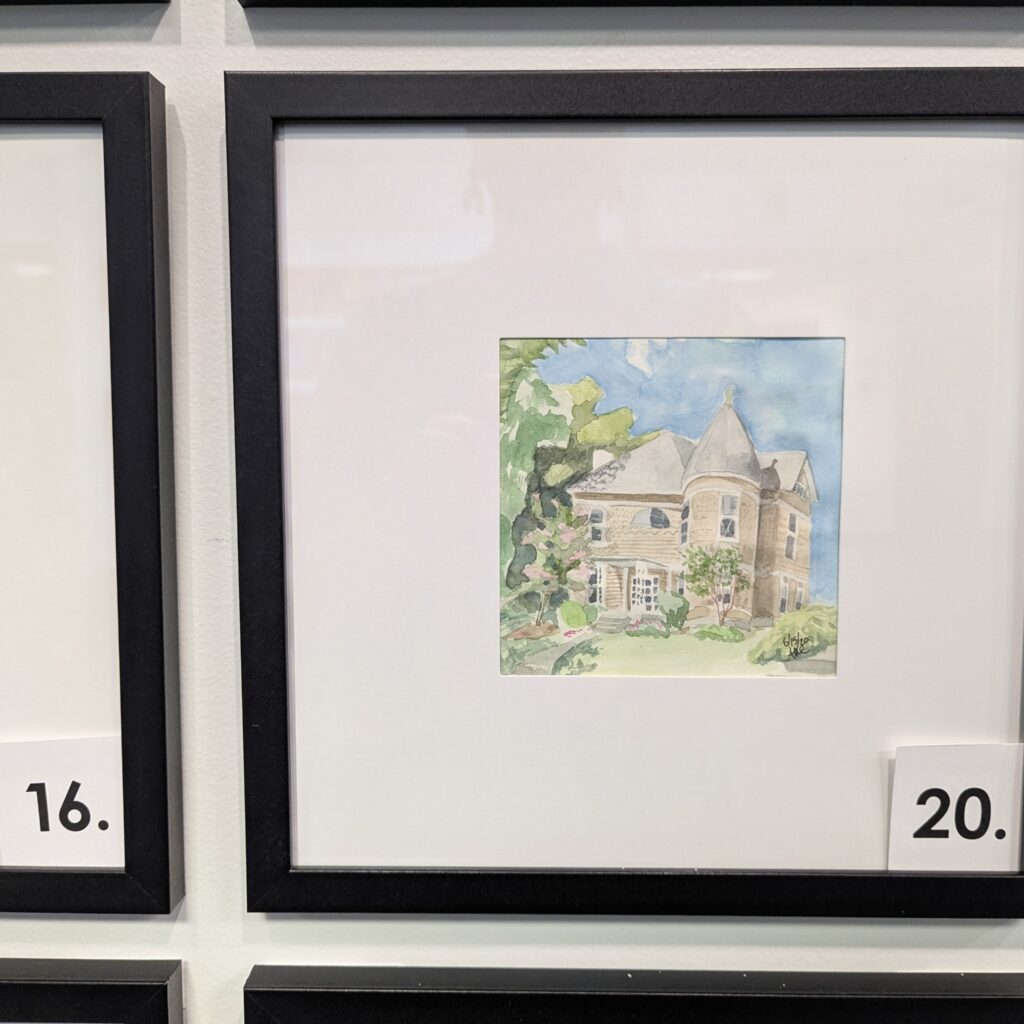 A 5x5 watercolor of a Victorian home, now office with an acorn tower. The painting is in a 10x10 frame.