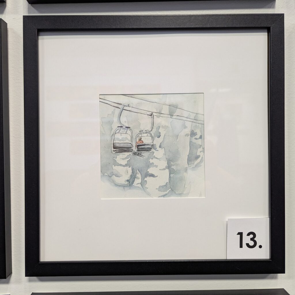 5x5 watercolor painting of a chairlift disappearing into a storm. It is in a 10x10 frame.